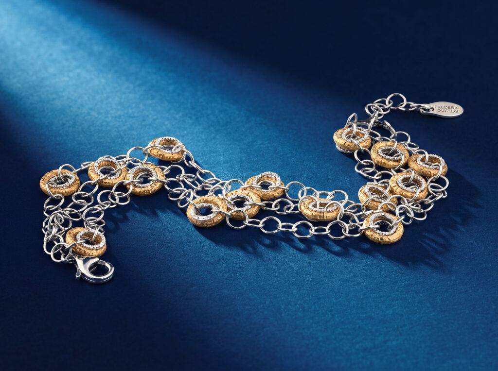 Frederic Duclos sterling silver multi-strand chain bracelet with diamond-set textured yellow gold links on blue