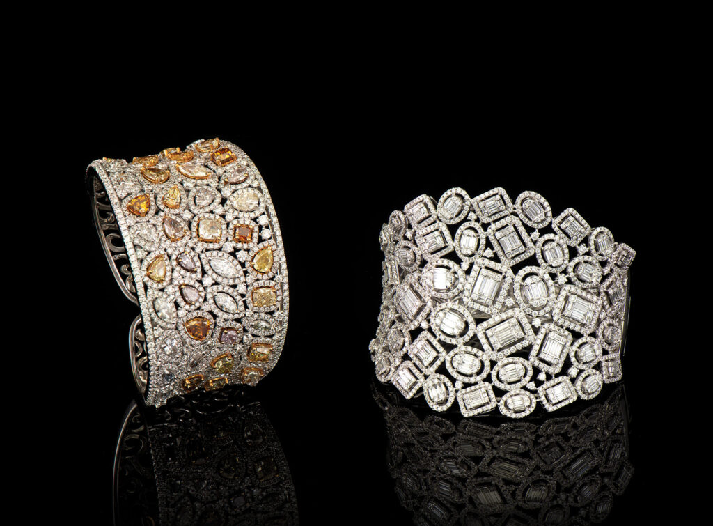 Two wide platinum cuff bracelets set with mosaic geometric yellow, cognac, and white diamonds